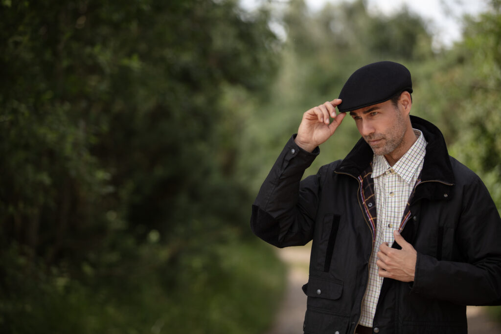 Man wearing a flat cap.